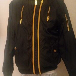 Womans Black Jacket with Gold  Zippers.